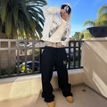 Model wearing white hoodie with black joggers